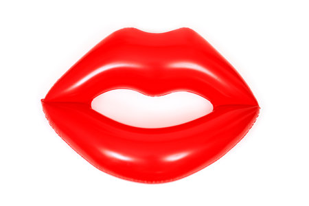 a floaty in the shape of a pair of red lips on a white backgroundの写真素材