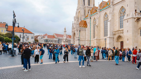 Budapest, Hungary - October 5, 2024: A lot of tourists walk around Matthias Church in the Buda side of Budapest, Hungary, on an autumn dayのeditorial素材