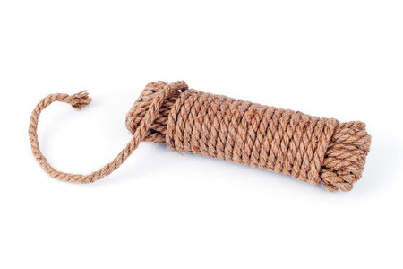 a coil of rope with a loose end on a white backgroundの写真素材