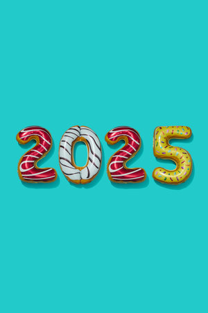 four foil balloons of different colors forming the number 2025, as the new year, on a blue background with some blank space on top and on the bottomの写真素材