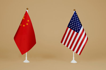 a flag of China and a flag of the United States standing side by side on a brown backgroundの写真素材
