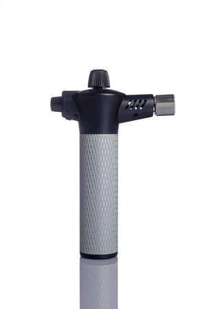 a handheld butane torch for kitchen use on a white backgroundの写真素材