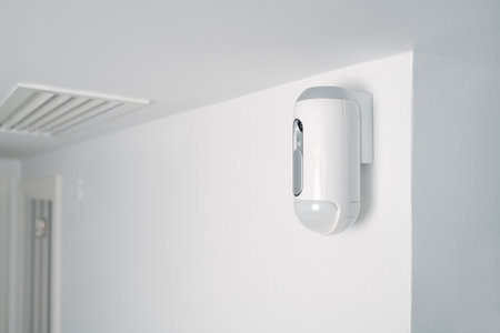 a motion detector equipped with a camera, mounted on a wall, indoors, as part of a burglar alarm systemの写真素材