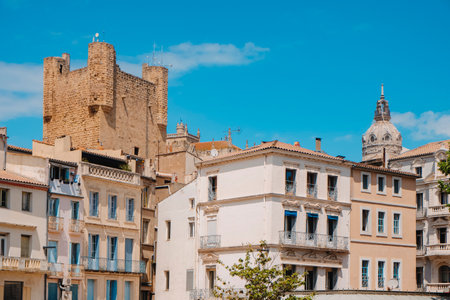 a view of the the old town of Narbonne, France, highlighting the Donjon Gilles Aycelin tower of the Palace of the Archbishops, on a sunny spring dayの写真素材