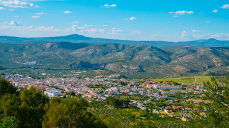 an aerial view of Cuevas de San Marcos, a small town in Malaga Province, Spain, surrounded by mountains, on a sunny spring dayの写真素材