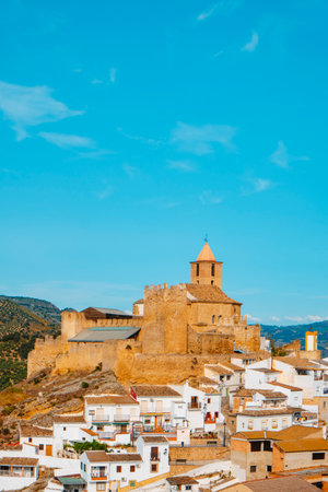 a view of Iznajar, a small whitewashed town built around its castle at the top of a hill, in Cordoba province, Spain, on a sunny spring dayの写真素材