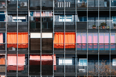 detail of a contemporary apartment complex featuring vivid orange awningsの写真素材