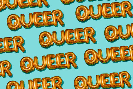 letter-shaped balloons spelling the word queer are repeated across a pale green background, creating a patternの写真素材