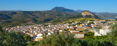 a wide view of Cuevas de San Marcos, Spain, with its white houses scattered at the foot of the...