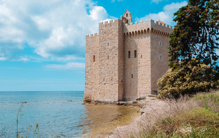 the medieval fortified monastery of the Lerins Abbey in Ile Saint-Honorat, France, surrounded by the Mediterranean seaの写真素材