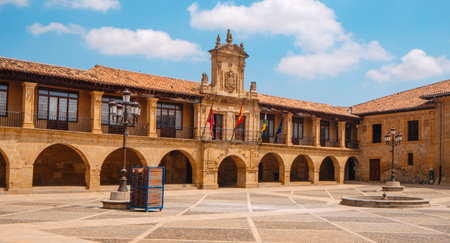 the historic Town Hall stands at the back of Plaza de Espana in Santo Domingo de la Calzada, Spain, on a sunny day with scattered cloudsの写真素材