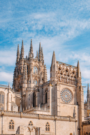 the south facade of the cathedral of Burgos in Spain, seen from Plaza del Rey San Fernando, featuring the ornate octagonal crossing lantern above the transeptの写真素材