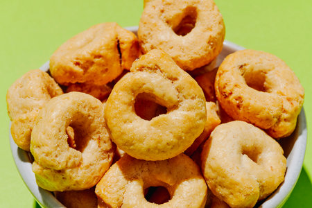 closeup of italian taralli ai semi di finocchio, rustic baked treats, crunchy and aromatic with fennel seeds, arranged in a simple white bowlの写真素材