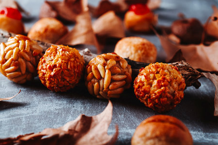 row of Catalan panellets made with pine nuts and almonds on a rustic gray surface, traditional sweets for All Saints Day in Catalonia, Spainの写真素材