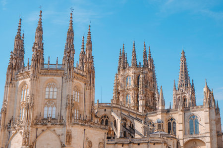 rear view of Burgos Cathedral showing the Condestable Chapel and the lantern tower, a masterpiece of Spanish Gothic architecture illuminated by warm afternoon lightの写真素材