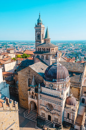 the Basilica di Santa Maria Maggiore and the ornate Cappella Colleoni in Bergamo Alta, Italy, seen from above with detailed architecture and the city stretching into the horizonの写真素材