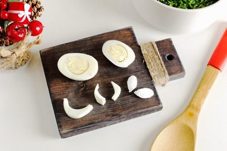 9. To decorate the salad, cut off a larger piece on one side of the egg and a smaller piece on the...
