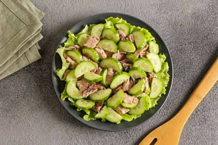 Slice the cucumber and add to the salad.の写真素材