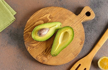 Wash the avocado and cut it in half.