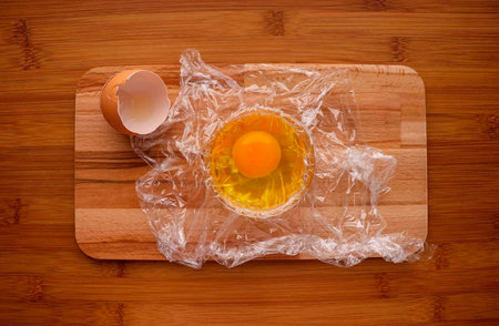 Crack the egg gently without damaging the yolk.