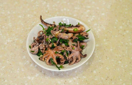 Transfer octopuses to a bowl, add vinegar and stir.の写真素材