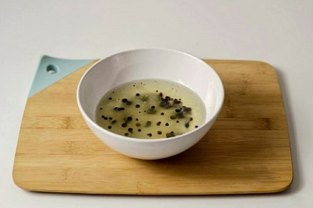 Pour vegetable oil into a large bowl. Start dripping the mixture into the oil until it is completely runny and warm.の写真素材