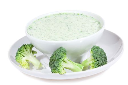 bowl of broccoli soup on white backgroundの写真素材