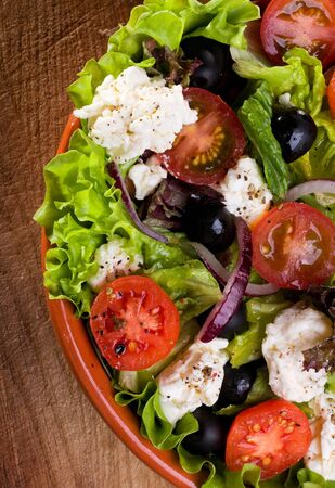 greek salad with fresh vegetables and feta cheeseの写真素材