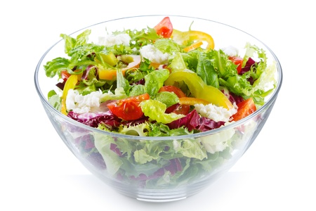 salad with greens and vegetables on white backgroundの写真素材
