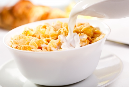 milk pouring into corn flakes の写真素材
