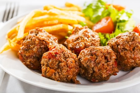 meat balls with fries and saladの写真素材
