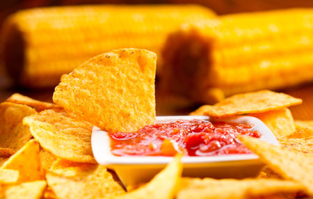 nachos with salsa on wooden tableの写真素材
