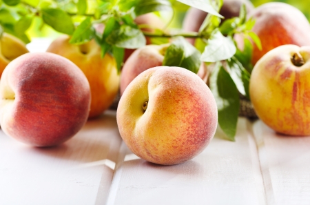 fresh peaches on wooden tableの写真素材