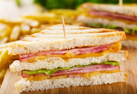 club sandwich with french fries on wooden tableの写真素材