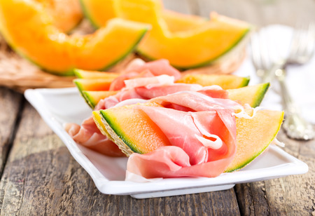 plate of cantaloupe melon with prosciuttoの写真素材