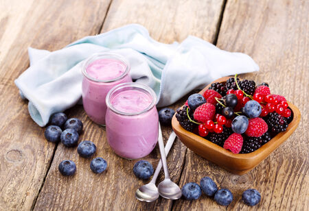 blueberry yogurt with fresh berries on wooden tableの写真素材