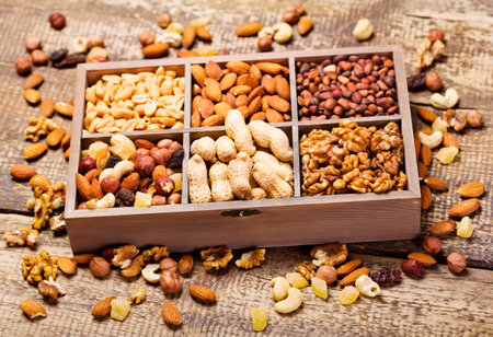 mixed dried nuts in wooden boxの写真素材