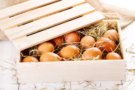 brown eggs in wooden boxの写真素材