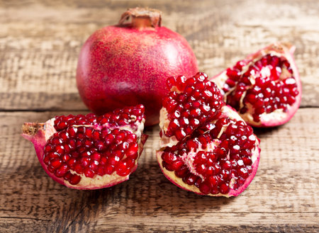 fresh pomegranate on wooden tableの写真素材