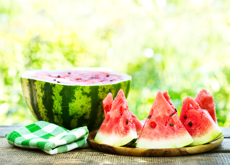 slices of watermelon on wooden tableの写真素材