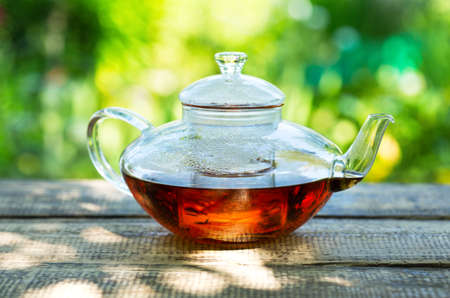 teapot with tea on wooden tableの写真素材