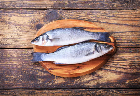 fresh fish sea bass on wooden tableの写真素材