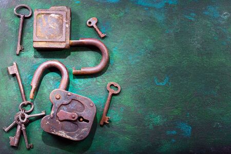 old  locks and keys on rusty backgroundの写真素材