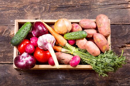 fresh vegetables in wooden box on wooden backgroundの写真素材