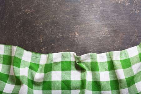 green checkered tablecloth on dark table, top view with copy spaceの写真素材