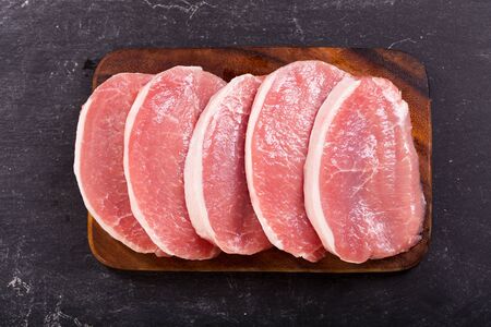 fresh pork on dark background, top viewの写真素材