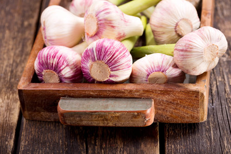 fresh garlic in a wooden box on a table