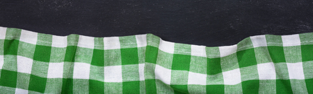 green checkered tablecloth on dark table, top view with copy space, bannerの写真素材