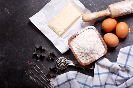 ingredients for baking : flour, eggs, butter and kitchen utensils for cookingの写真素材