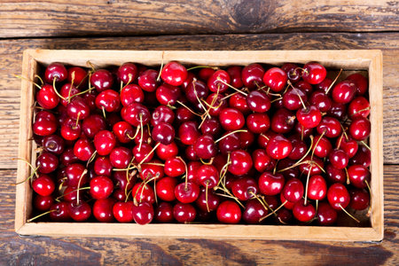 fresh cherries in wooden box on a table